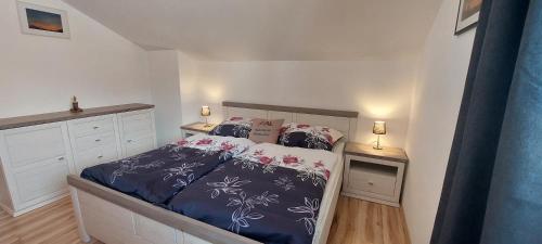 蓬高圣约翰Apartment ZIRMWEBER-Haus的一间卧室配有一张铺有紫色和白色床单的床