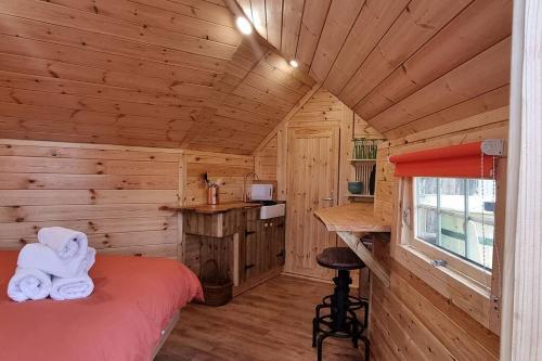 巴茅思Woodland Cabin with Hot tub & log burner的小木屋内一间卧室,配有一张床