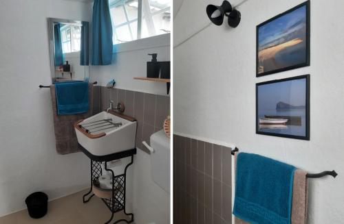 CalodyneKailani的浴室设有水槽和带蓝色毛巾的卫生间。