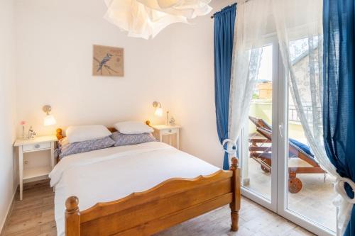 皮罗瓦茨Apartment Lolić Pirovac的一间卧室设有一张床和一个滑动玻璃门