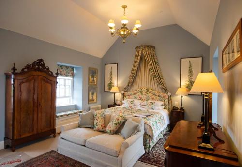 瑟索The Granary Lodge Bed & Breakfast的一间卧室配有一张床和一张沙发