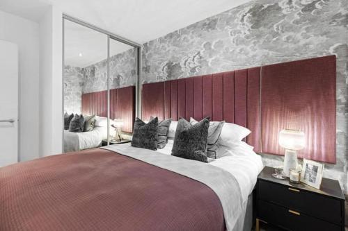 OltonLuxury Modern, One bedroom Flat的一间卧室配有一张大床和红色床头板