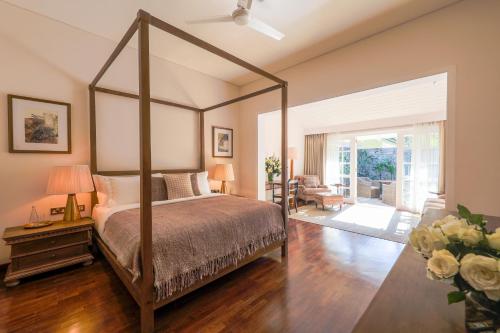 康提W15 Hanthana Estate Kandy的一间带天蓬床的卧室和一间客厅