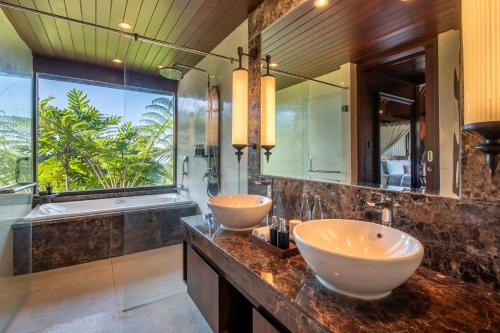 贝都古HOMM Saranam Baturiti, Bali的带大窗户的浴室内的2个盥洗盆
