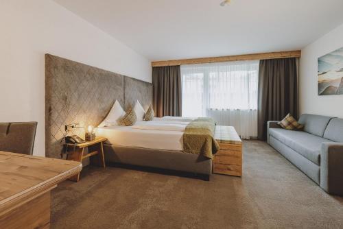萨尔巴赫Der Gollinger的酒店客房,配有床和沙发