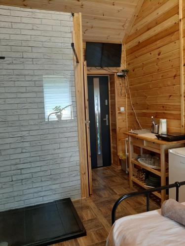 Domek dla par agroturystyka siedlisko的卧室设有木墙和一扇门。