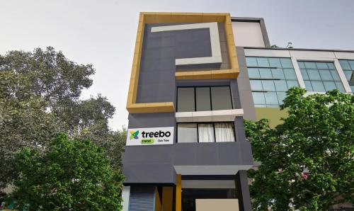 新德里Treebo Trend Prime Elight的建筑的侧面有三角形标志