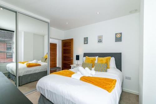 圣奥尔本斯*20% off Monthly* St Albans City Centre Apartment的一间卧室设有两张床和大镜子