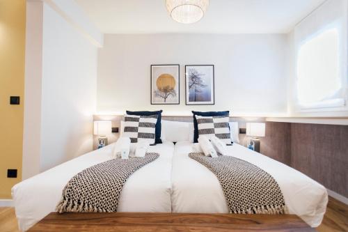 塞维利亚Modern and luxury- 2Bd 2Bth- Socorro的卧室配有一张带两个枕头的大白色床