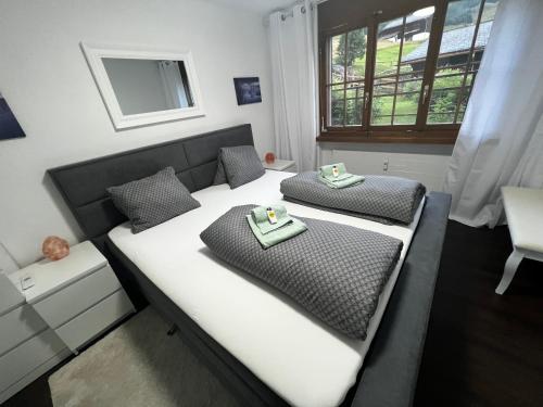 RuerasCasa Ucliva - Charming Alpine Apartment Getaway in the Heart of the Swiss Alps的一间卧室配有一张床,上面有两道菜
