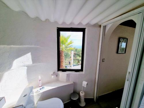 Tejina de IsoraEtoile arc-en-ciel的白色的浴室设有浴缸和窗户。