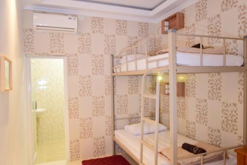 日惹The Cabin Purwokinanti Hotel的一间房间,设有三张双层床