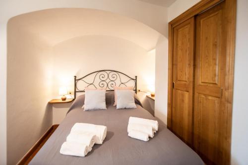 卢卡Casetta di Butia, Appartamento Iris的一间卧室配有一张床,上面有两条毛巾