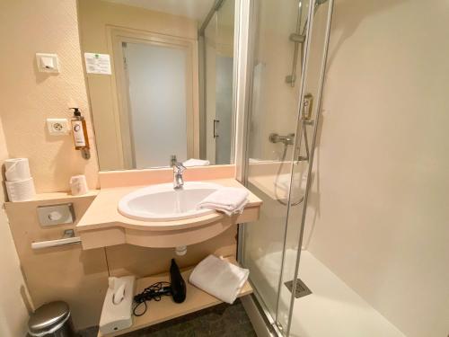 雷恩Hotel Le Sevigne - Sure Hotel Collection by Best Western的一间带水槽和淋浴的浴室