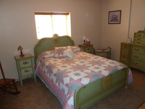 卡纳布Red Rock Hacienda的一间卧室配有床,床上装有被子