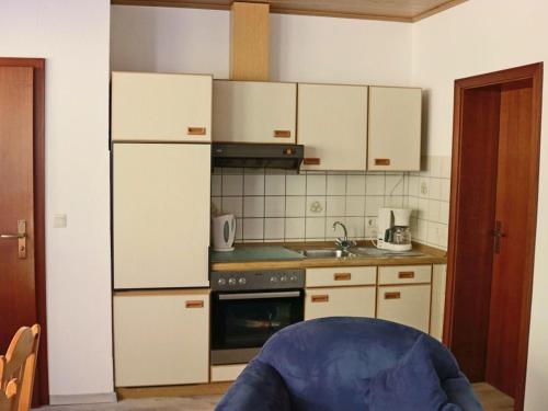 梅德巴赫祖尔多先科酒店的厨房配有白色橱柜和炉灶烤箱。