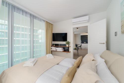 米兹多洛杰Sea Waves Apartament Resort & SPA 428B by Renters的带沙发和电视的白色客厅