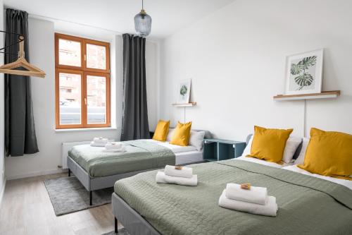 柏林Komm rein und fühle dich zu Hause direkt nahe der Altstadt Spandau und am Wasser的黄色和绿色的客房内的两张床
