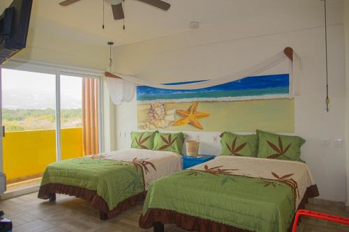 锡瓦塔塔内霍Hotel Happy Beach的一间卧室设有两张床,墙上挂着一幅画