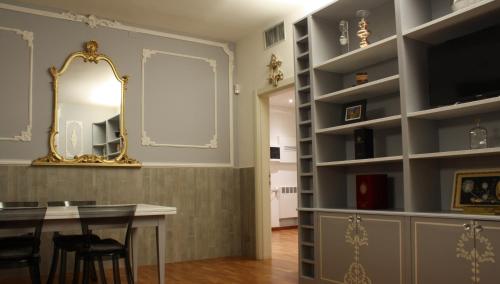 博洛尼亚Appartamento blu centro storico的一间带桌子和镜子的用餐室
