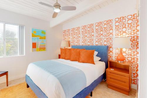 棕榈泉Desert Willow Mod Permit# 5268的卧室配有蓝色和白色的床以及橙色枕头