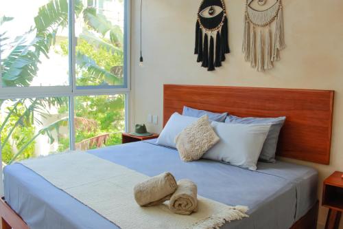 图卢姆Gama 09 Apartments的一间卧室设有一张蓝色的床和大窗户