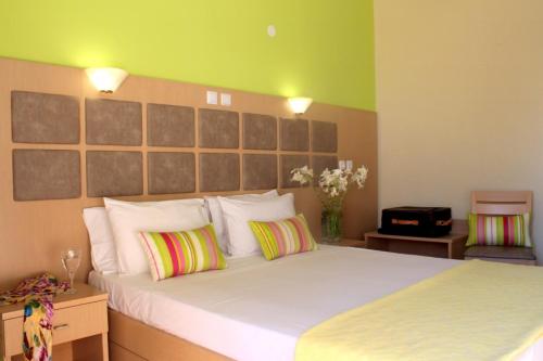 佩弗卡里Thassos Hotel的卧室配有一张带两个枕头的大白色床