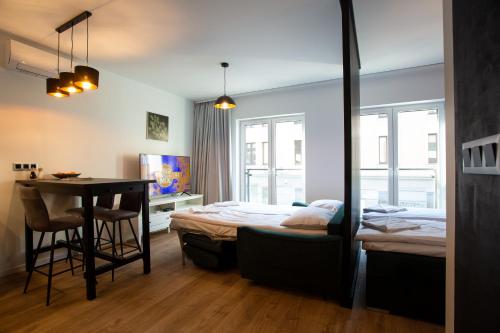 克拉科夫Sunny Apartment Lwowska 10的一间卧室配有一张床、一张桌子和一张书桌