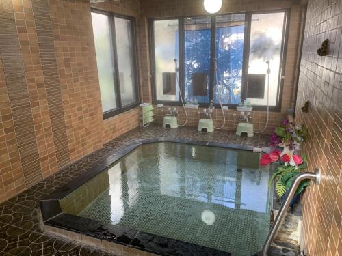 松本末广酒店的游泳池,浴室设有窗户