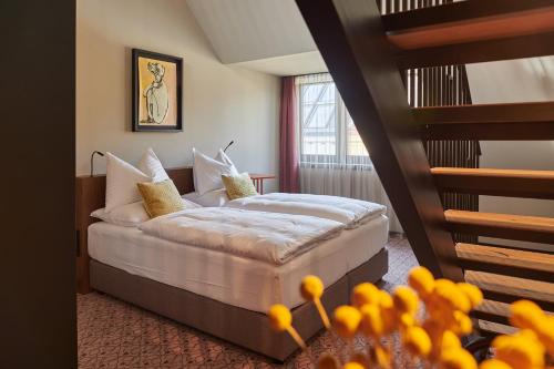 维也纳WELTWIEN Luxury Art Apartments的一间酒店客房,设有一张床和一个楼梯