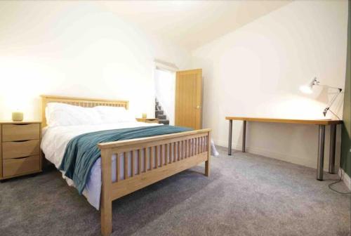 贝尔法斯特Casement Townhouse的一间卧室配有一张大床和一张书桌