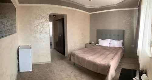 塞凡Hotel MARUNA的一间卧室,卧室内配有一张大床