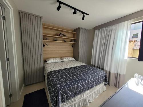 伊泰帕瓦Vila Piemont Itaipava的一间卧室配有一张带木制床头板的床