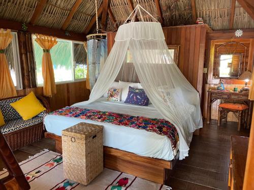 锡瓦塔塔内霍Bungalows Tree Tops - Adults Only的一间卧室配有一张带蚊帐的床