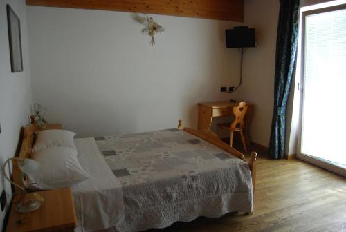 蒙克拉西科尼道戴乐阿贵勒住宿加早餐酒店的一间卧室配有一张床、一张桌子和一个窗户。
