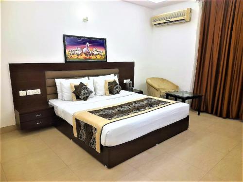 诺伊达Tavisha Villa Flim City Road Dadri Road的一间卧室,卧室内配有一张大床