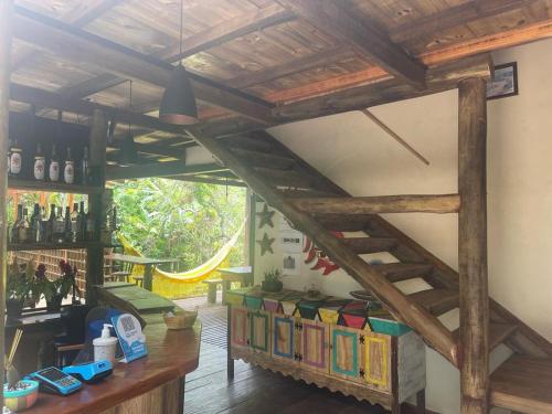 帕拉蒂Pousada Meraki Paraty Mirim的一间设有木制楼梯和书籍的房间