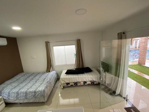 圣若泽-达科罗阿格兰迪Vila Bangalô的一间卧室设有两张床和窗户。