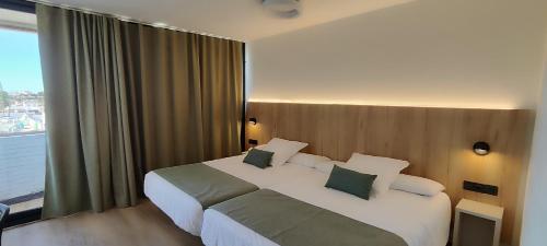 马塔拉斯卡尼亚斯Ohtels Carabela的酒店客房设有一张床和一个大窗户