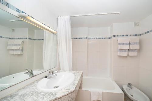 伊维萨镇大海与沙滩公寓的白色的浴室设有水槽和浴缸。