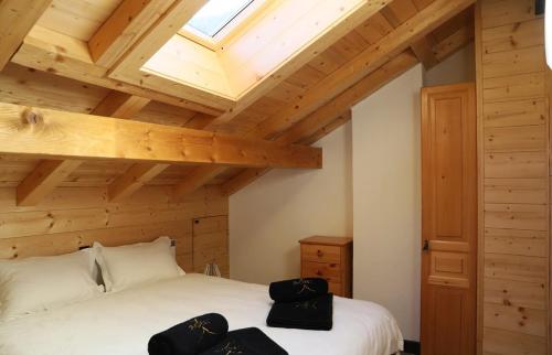 SalvanCosy&star的卧室配有白色床和木制天花板
