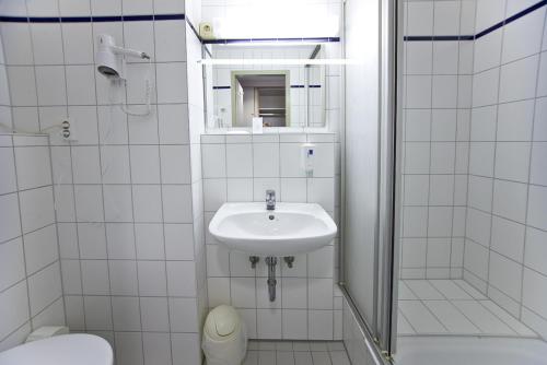 哥廷根雷纳酒店的白色的浴室设有水槽和卫生间。