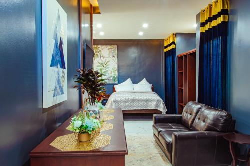 Baclayon马克西斯日出日落Spa度假村的酒店客房配有一张床和一张皮沙发