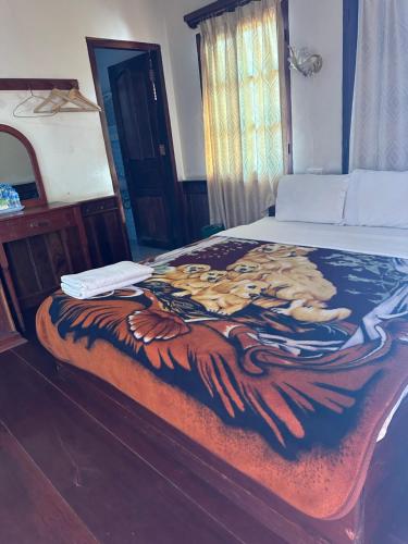 北宾BKC Villa 2的一张带毯子的床,上面有一只鹰的照片