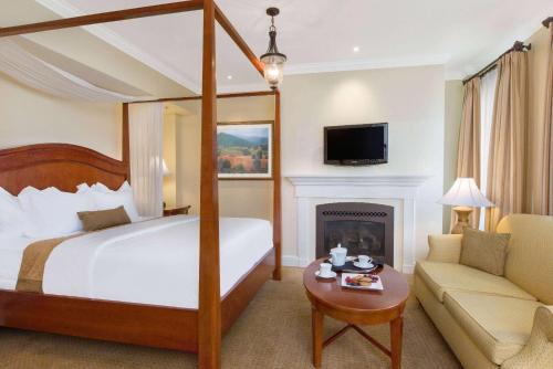 温彻斯特The George Washington - A Wyndham Grand Hotel的酒店客房配有一张床和一个壁炉。