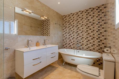 贝纳尔马德纳Luxury Villa Andalucia Seaview Private Pool close to Centre的一间带水槽、浴缸和卫生间的浴室