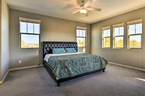 吉尔伯特Spacious Gilbert Vacation Rental with Patio!的一间卧室配有一张带吊扇和窗户的床。