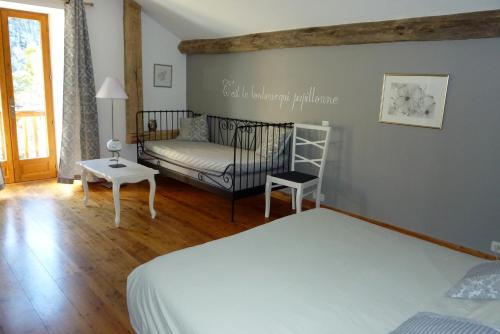 Saint-André-dʼEmbrun奥利维耶乐姆林酒店的一间卧室配有一张床和一张沙发