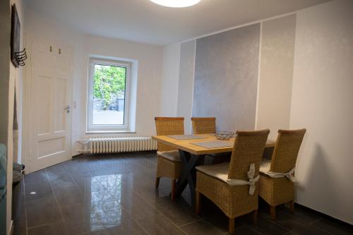 萨尔堡Ferienwohnung mitten in Saarburg的一间带桌椅和窗户的用餐室
