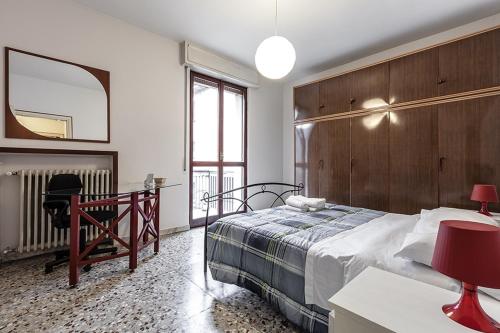 米兰MilanRentals - Vigliani Apartments的一间卧室配有一张床、一张书桌和一面镜子